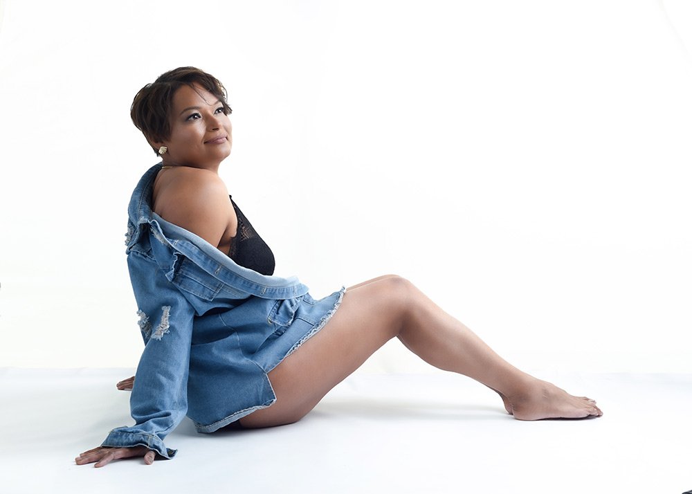 Toronto boudoir photography. A woman in a jean jacket showing off her legs.