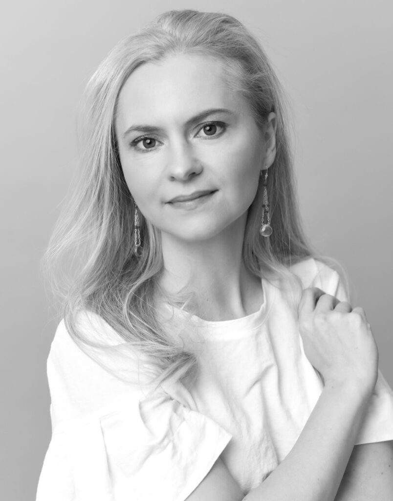 A woman with a serene expression, posing for a portrait by a glamour photographer