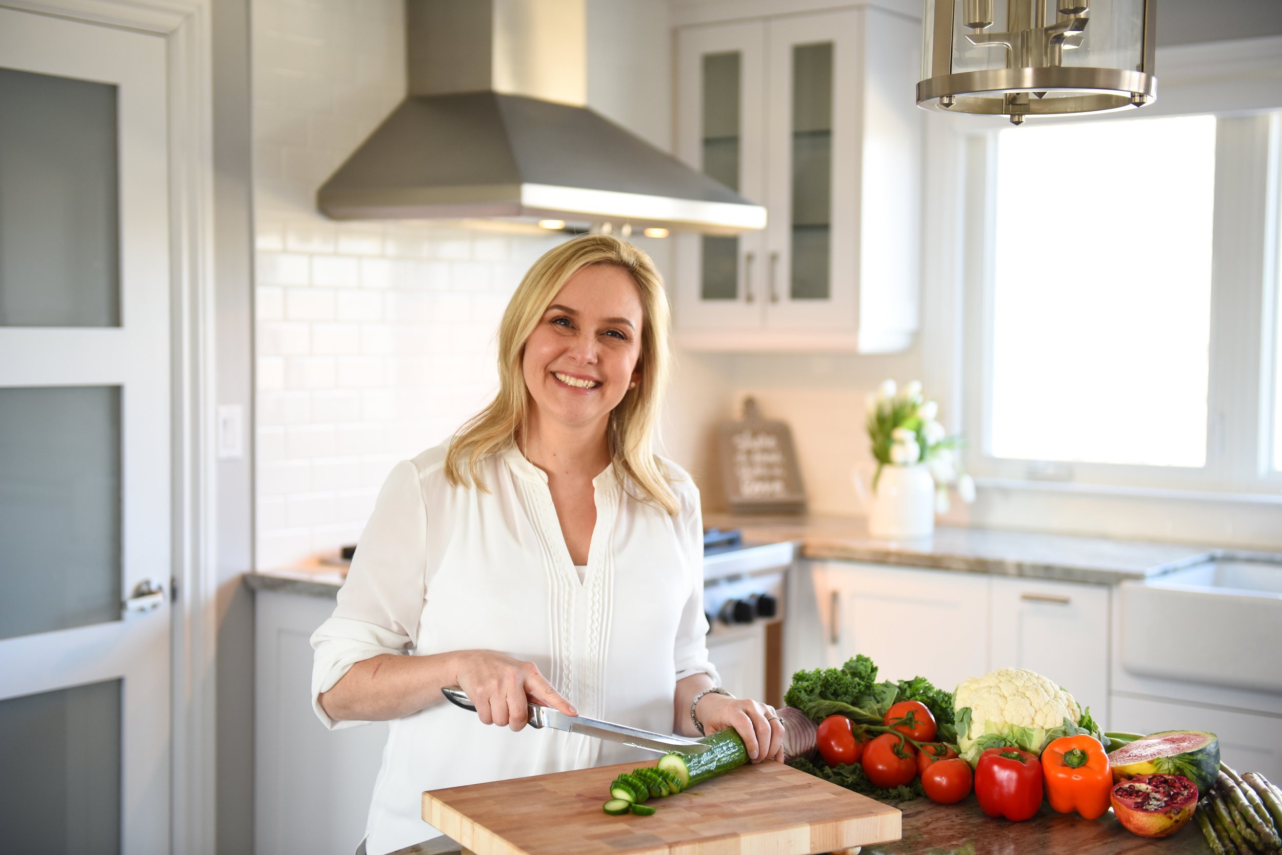 Woman preparing vegetables in a bright, modern kitchen