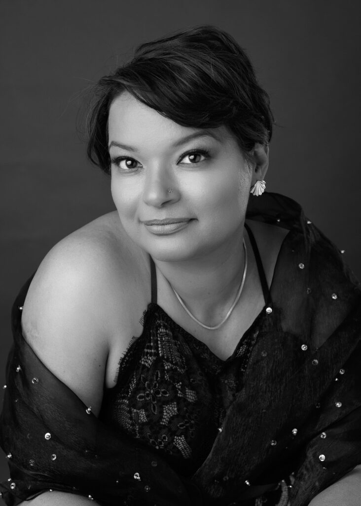 A woman posing elegantly with gloves, captured by a glamour photographer.