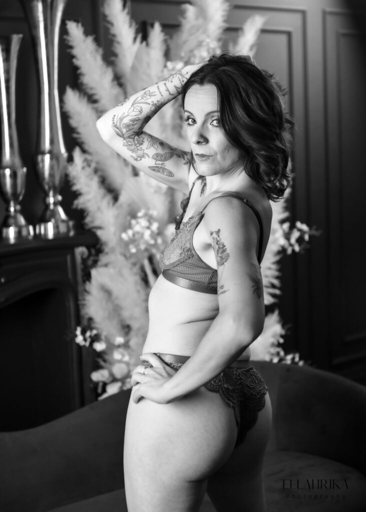A confident woman in lingerie captured in an empowering boudoir photo shoot in Toronto, highlighting her beauty and strength