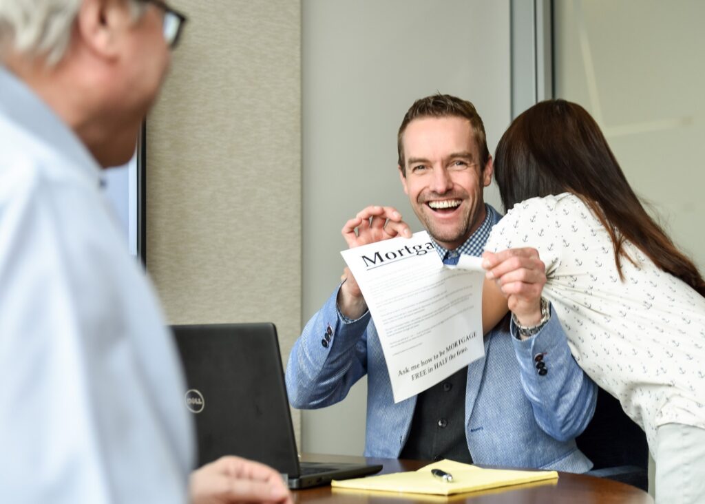 Man holding a mortgage document and smiling during a meeting - how to take personal branding photos for Instagram.
