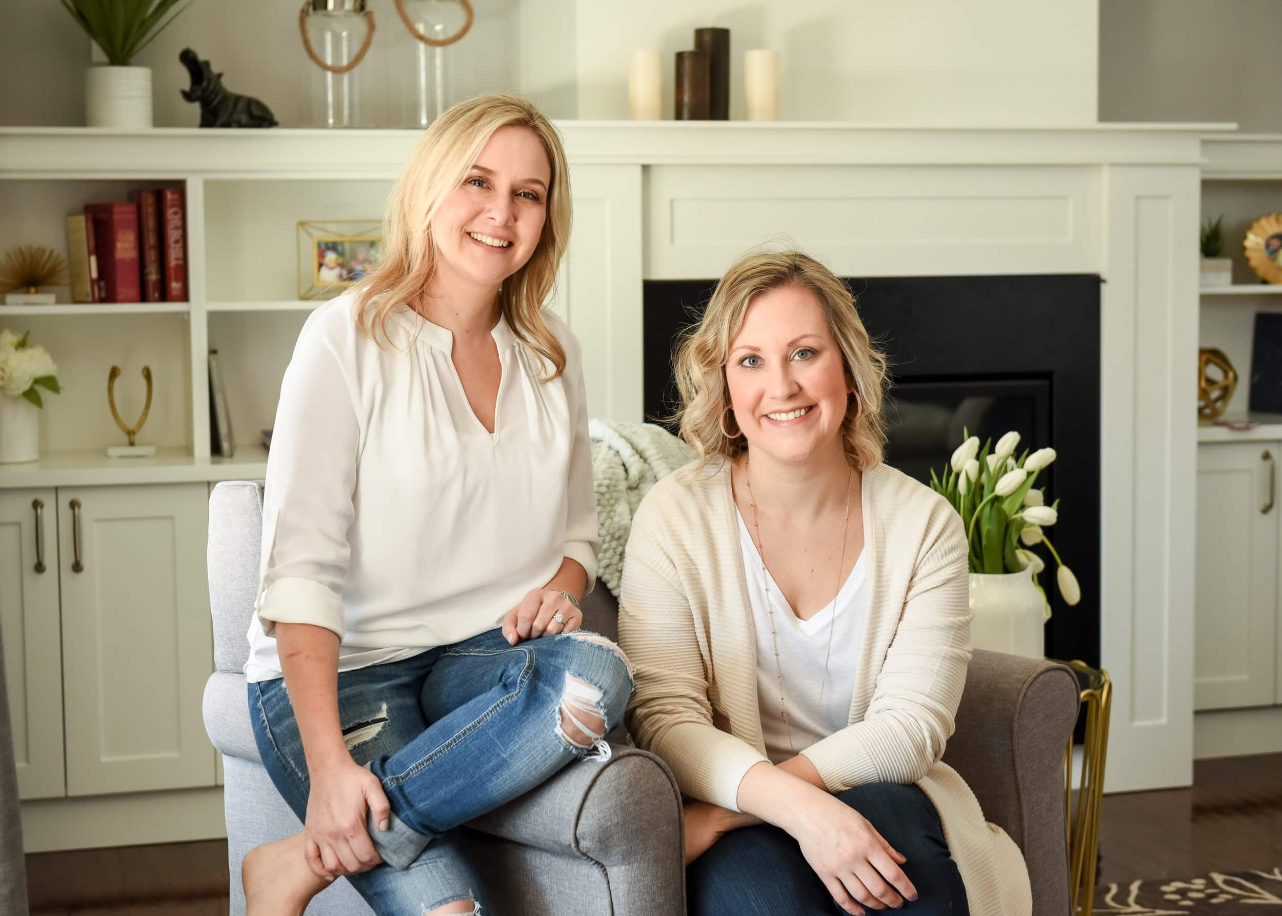 Two women sitting in a cozy living room, smiling at the camera - how to take personal branding photos for Instagram.