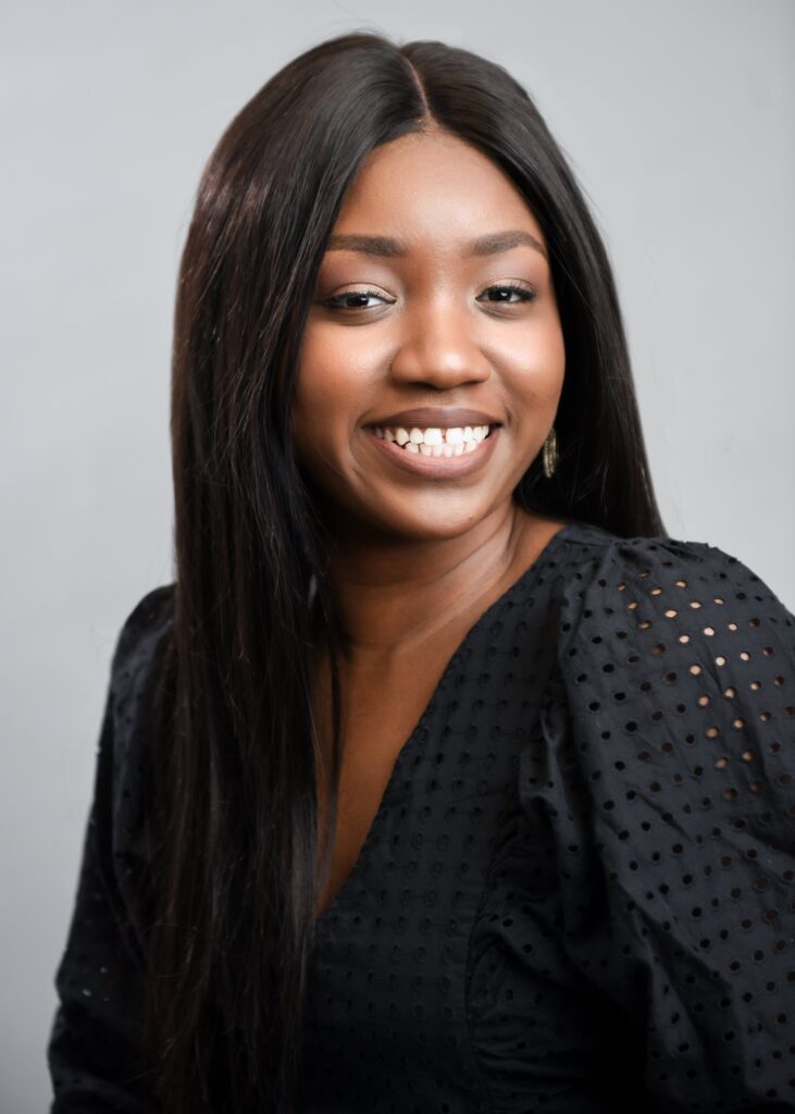 Professional headshot of a woman with long dark hair, dressed in a black outfit, showcasing a confident and professional look - headshots Toronto.