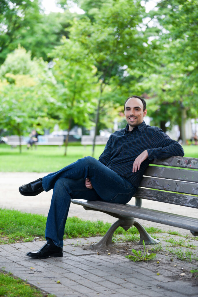 Man sitting on park bench smiling