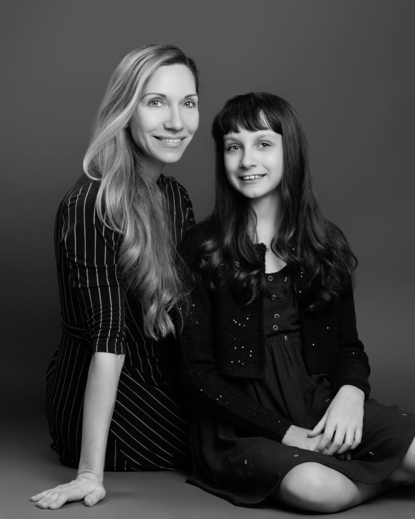 Mother and daughter sharing a joyful moment during a mother daughter photoshoot