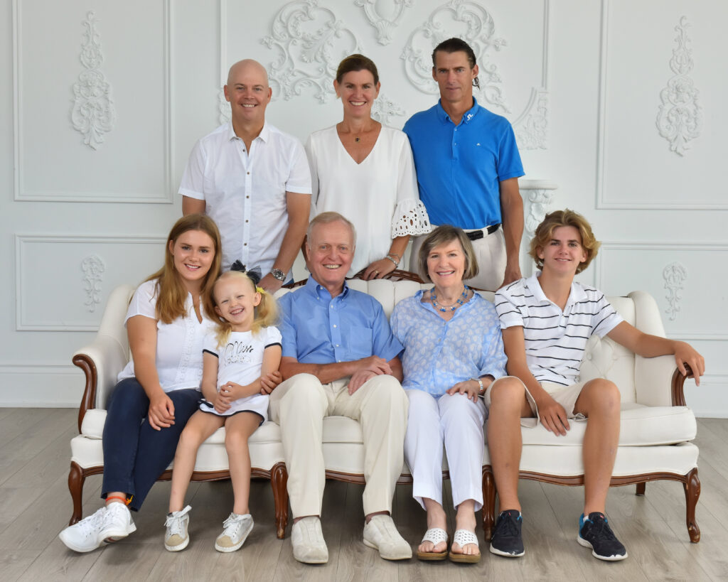 An extended family portrait session in a studio with grandparents and grandchildren, showcasing the best family photographers near me.