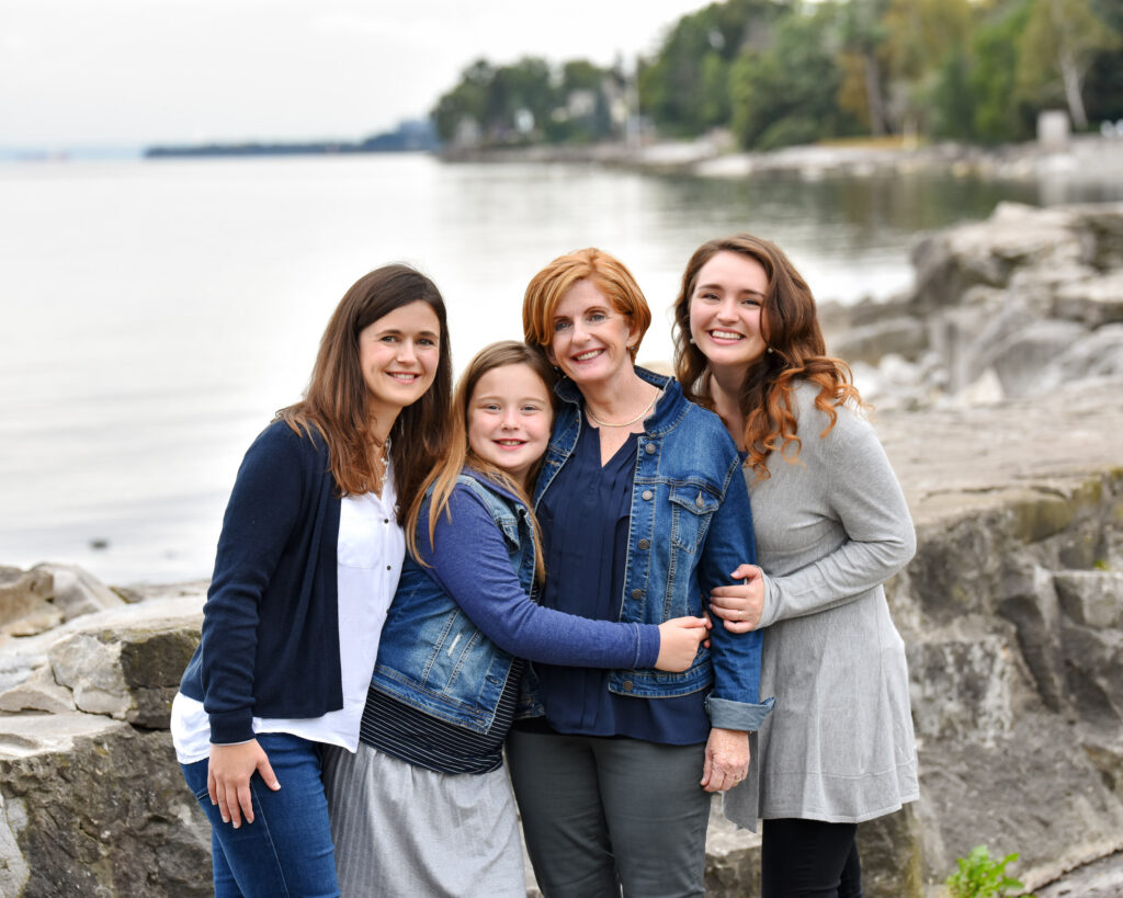 A multi-generational family portrait by the lake, taken by the best family photographers near me, highlighting natural settings.