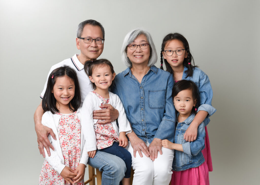 A studio family portrait featuring grandparents, parents, and children, exemplifying the work of the best family photographers near me.