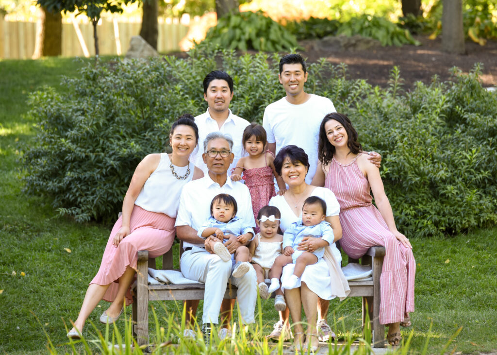 An extended family portrait in a blooming garden, captured by the best family photographers near me, featuring vibrant flowers.