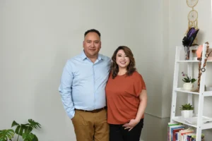 Professional counselors standing together in a cozy office environment.