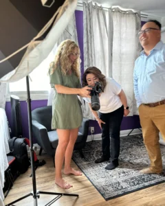 Photographer capturing a headshot of a couple in a bright and airy counseling office.