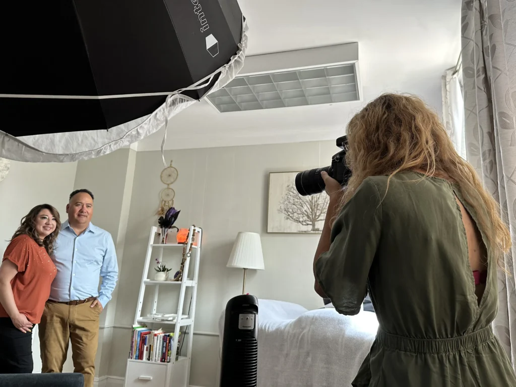 Photographer capturing a professional headshot for a female counselor in a studio setting.