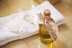 Decorative bottle of olive oil and a towel set prepared for a baptism ceremony.