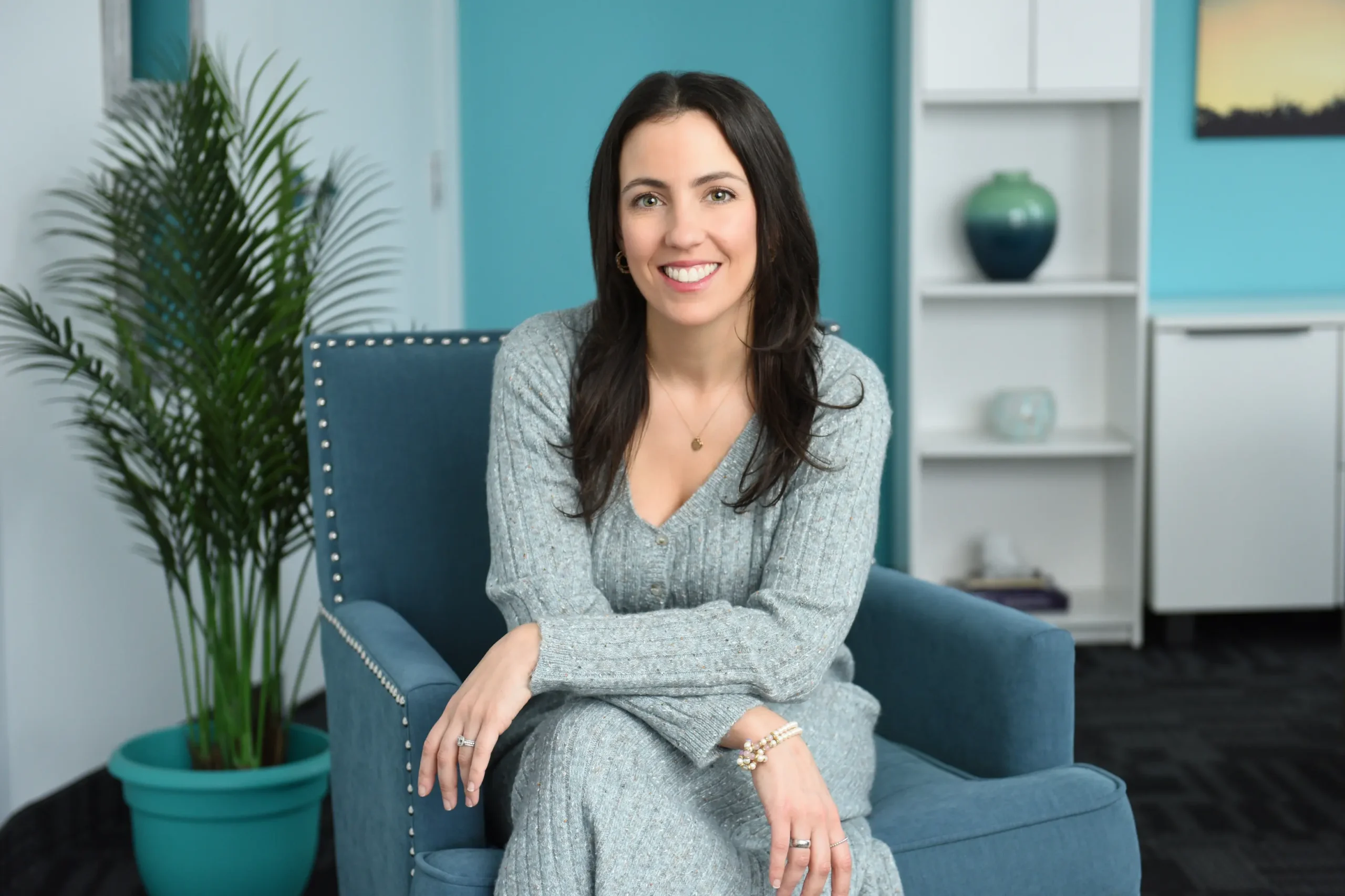 Professional headshot of a woman in a cozy office setting, showcasing approachable branding for Nuvista Mental Health.